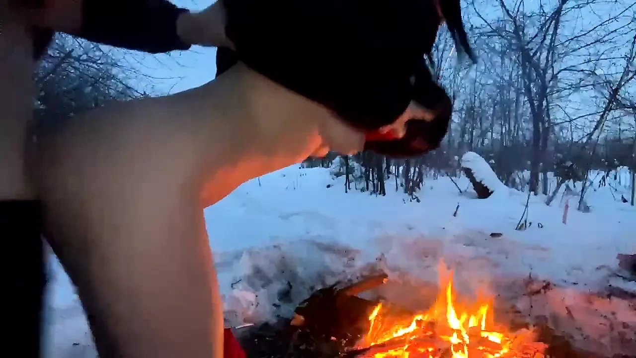 A guy and a girl fuck in the winter by the fire
